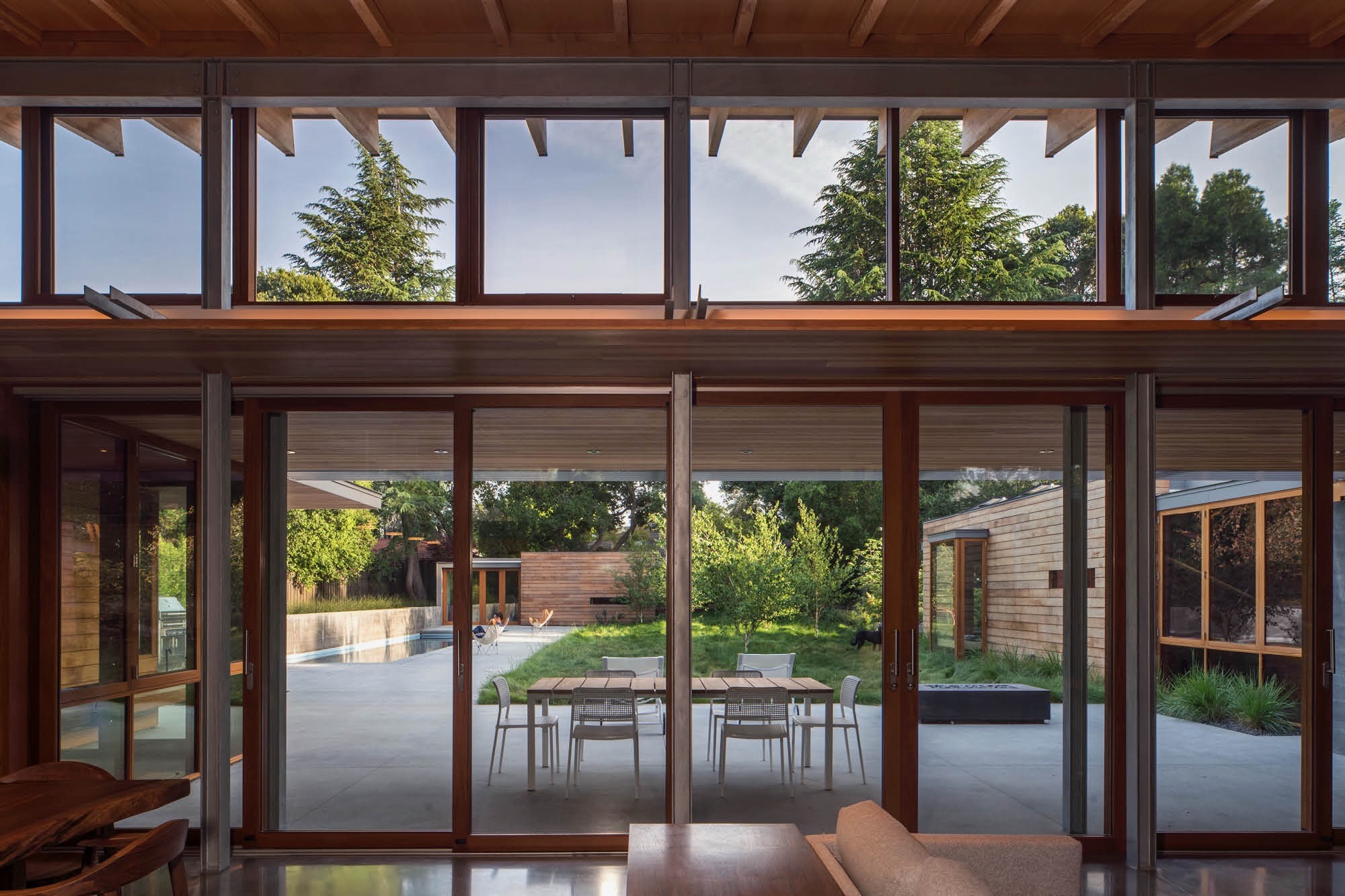Living area opening fully onto a garden terrace